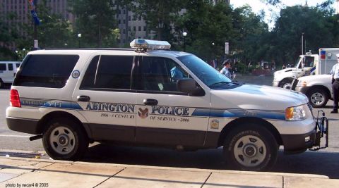2006 Ford F-150 - Abington Police SUV, marked "OF SERVICE - 2006", parked on a street with another vehicle in the background.