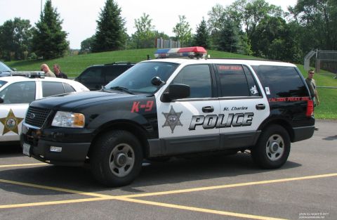 2006 Ford F-150 - A police SUV with 'St. Charles POLICE' and K-9 markings is parked in a lot.