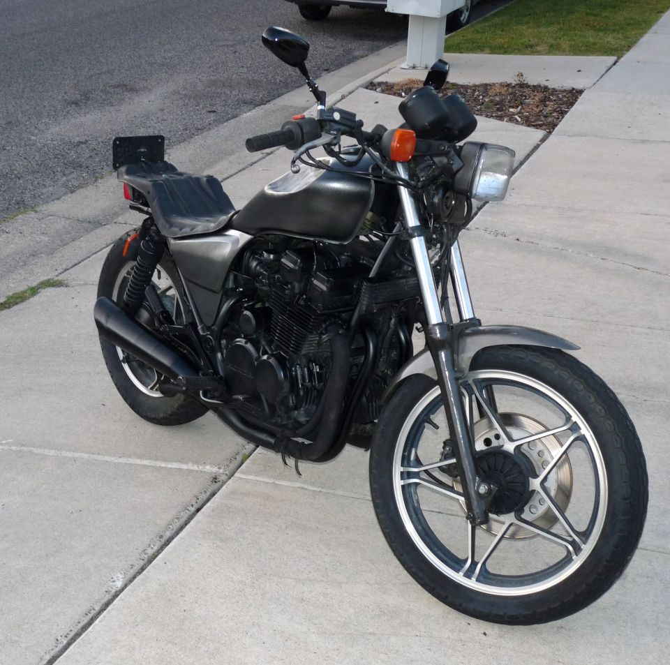 Black standard motorcycle parked on a driveway