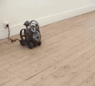 1969 Ford Fairlane - A peculiar mechanical device with wheels and gears is shown on a wooden floor.