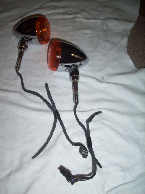 2006 Harley-Davidson Sportster Custom - Pair of motorcycle turn signals with amber lenses and wiring.