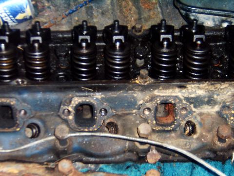 1982 Ford Bronco - Close-up of an engine cylinder head with visible valves and springs.