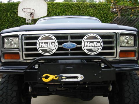 1985 Ford Bronco - This Ford Bronco features a custom bumper with a winch and auxiliary lighting, mounted in front of a basketball hoop.