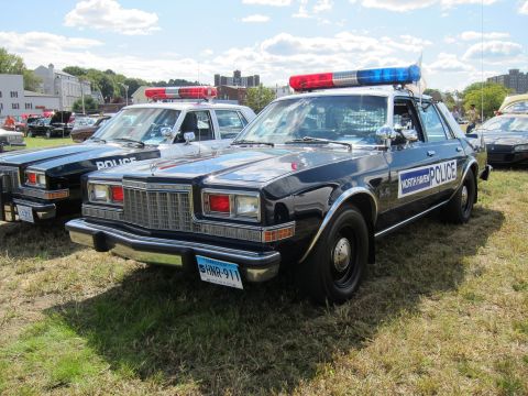 1991 Ford LTD Crown Victoria - vintage North Haven Police patrol sedan with a red-and-blue roof light bar sits on grass at an outdoor police car show.