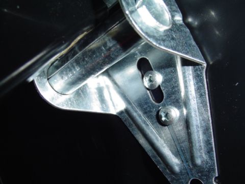 1999 Ford Taurus - Detail of a trunk latch mechanism, showing metal components and fasteners.