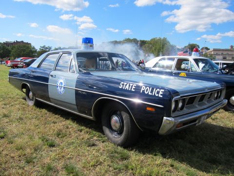 1991 Ford LTD Crown Victoria - vintage two-tone blue and white State Police sedan with a single roof light parked on grass at a car show.