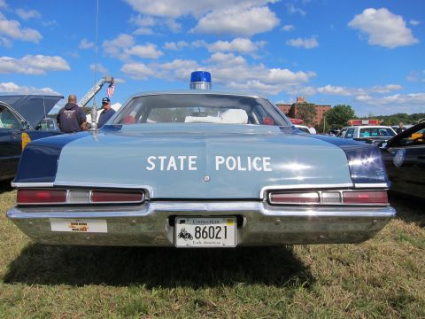 1991 Ford LTD Crown Victoria - Front view of a light blue State Police sedan with a single blue dome light and Connecticut plate reading 86021, on grass.