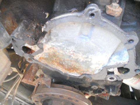 1991 Ford Bronco - A close-up view of a damaged engine part, showing signs of corrosion and wear.
