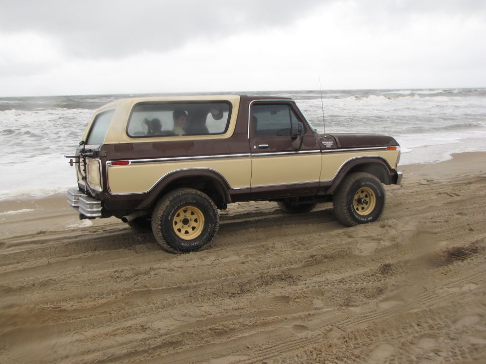 1979 Ford Bronco on beach, brown and tan two-tone paint, spare tire on rear