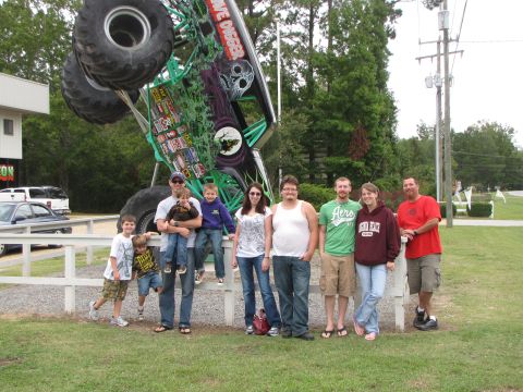 1979 Ford Bronco - A family poses for a photo in front of the Grave Digger monster truck.