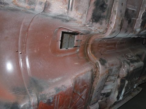 1973 Pontiac Trans Am - The undercarriage of a vehicle shows signs of rust and wear, with a visible square cutout in the metal.