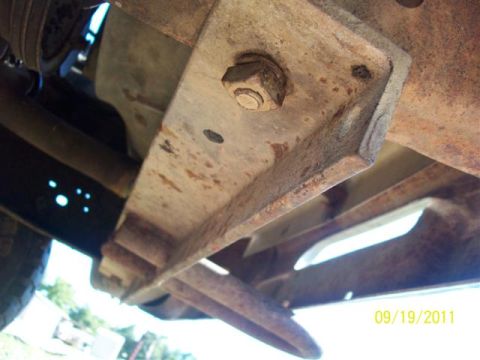 1979 Ford F-150 - Close-up of vehicle undercarriage components, showing rust and a date stamp from 2011.