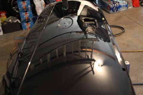 2006 Ford F-350 - A shiny black tailgate is shown in a garage setting, reflecting its surroundings.