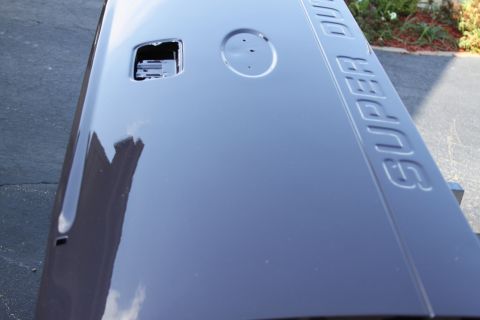 2006 Ford F-350 - A dark gray tailgate with embossed 'SUPER DUTY' lettering is shown from a close-up angle.