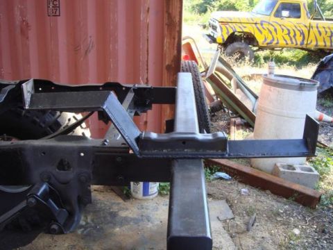 1982 Ford F-100 - Truck frame and parts with a tiger-striped truck in the background.