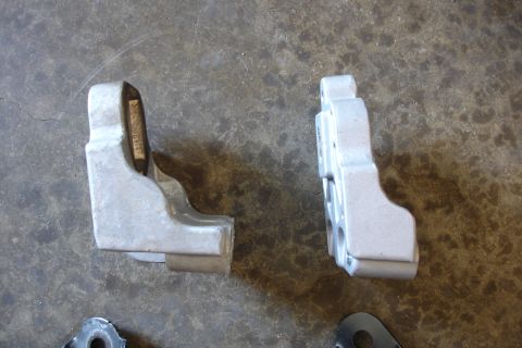 2006 Ford Fusion - Two engine mounts are shown on a gray, textured surface.