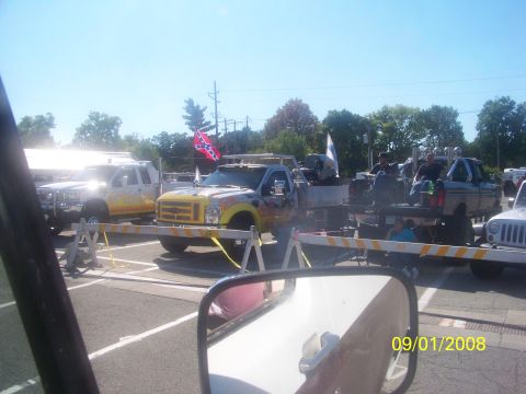 1989 Ford Bronco - Several trucks are parked together, with one flame graphics and a Confederate flag visible.