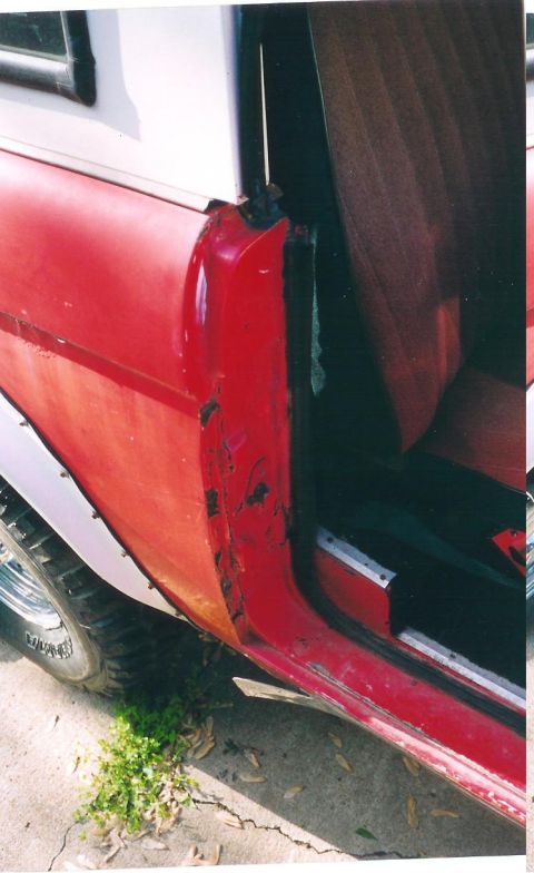 1974 Ford Bronco - Close-up view of the interior door jamb and seat of a red 1974 Ford Bronco.