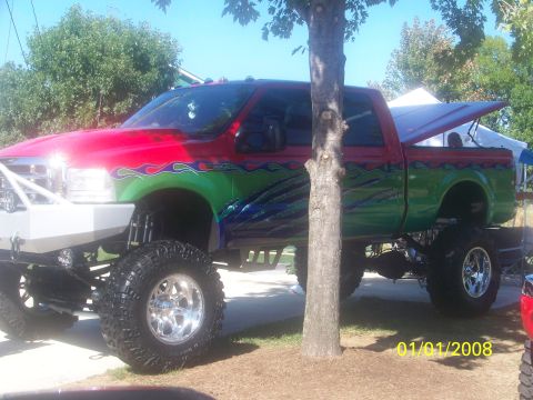1989 Ford Bronco - This heavily modified pickup truck features a custom paint job and oversized tires.
