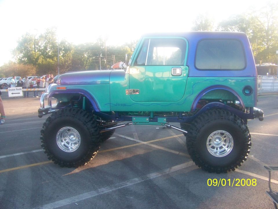 Modified Jeep CJ-7 with teal and purple paint, lifted suspension, and large tires. Date stamp reads 09/01/2008