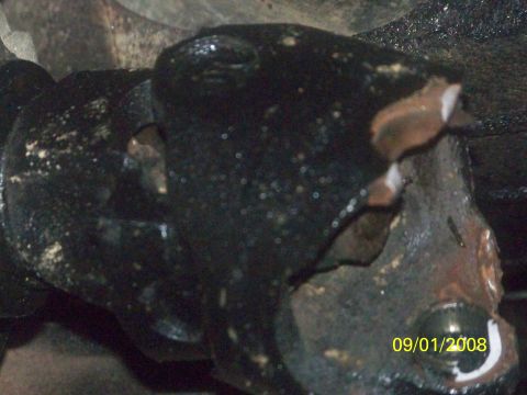 1989 Ford Bronco - Close-up of a damaged driveshaft joint, showing wear and tear with a date stamp.