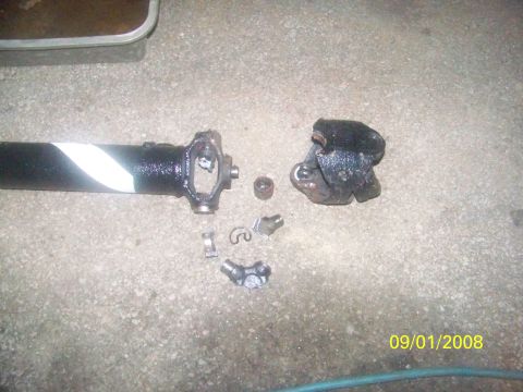 1989 Ford Bronco - A broken driveshaft and its components lie on a concrete surface, dated 09/01/2008.