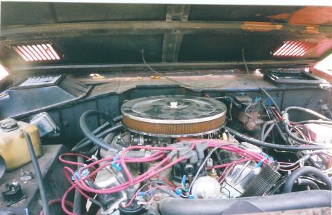 1974 Ford Bronco - The engine bay of a vehicle, showing the V8 engine and associated components.