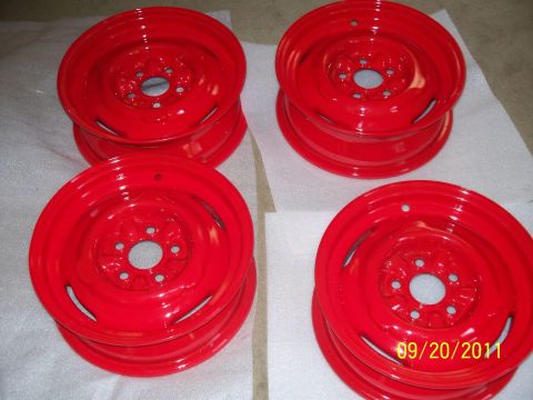 1990 Ford Bronco - A set of four red steel wheels are displayed on a white surface.