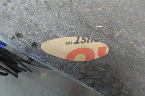 1997 Ford Ranger - A sticker with partial text and an orange number is affixed to a textured surface.