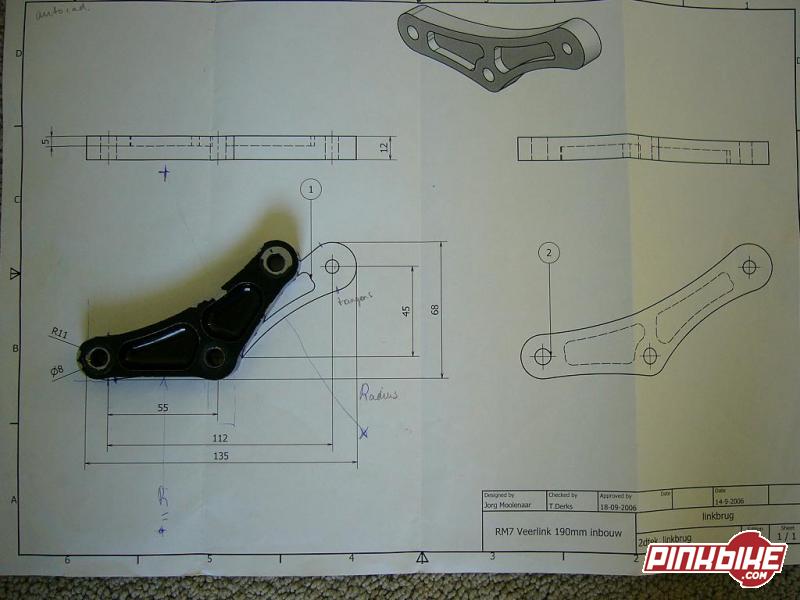 Engineering blueprint of a bracket link with dimensions and title block, part placed on it