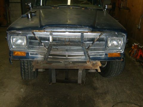 2000 Ford E350 - Front view of a dark colored pickup truck with a custom metal bumper modification.