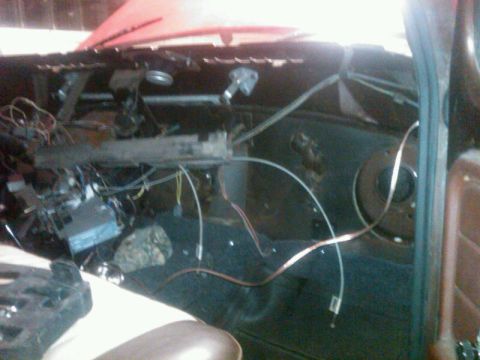 1979 Ford Bronco - The interior of a vehicle shows exposed wiring and dashboard components, suggesting a project or repair in progress.