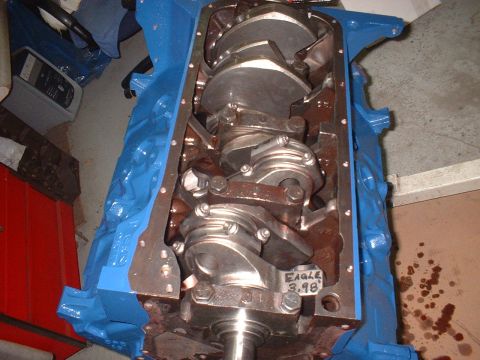 1969 Ford Mustang - The internal components of an engine block are shown, with a blue painted exterior and a visible crankshaft.
