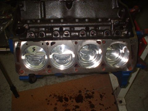 1969 Ford Mustang - Close-up view of an engine block with pistons installed, showing cylinder numbers.