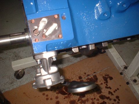 1969 Ford Mustang - The engine block and oil pump assembly are shown, with oil stains visible on the floor.