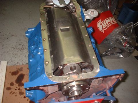 1969 Ford Mustang - Engine block with oil pan removed, revealing the crankshaft and internal components. A red Summit Racing Equipment bag is visible in the ba…
