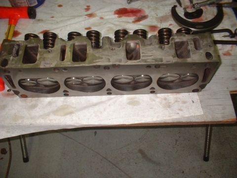 1969 Ford Mustang - A disassembled engine cylinder head is shown, with its valves and springs visible.