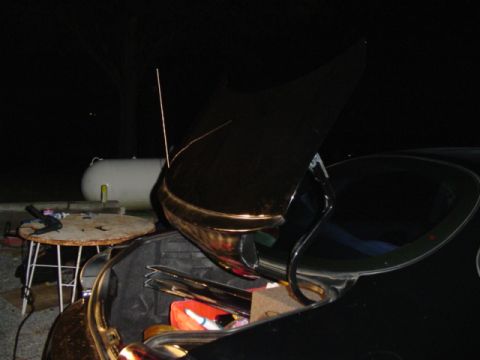 1999 Ford Taurus - Car trunk open at night, with a propane tank visible in the background.