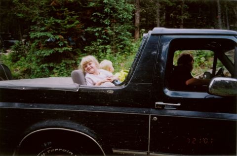 1995 Ford Bronco - Children enjoy a ride in a black 1995 Ford Bronco during an outdoor excursion.