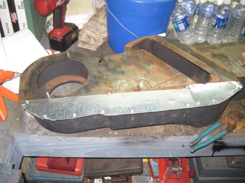 1979 Ford Bronco - Heater box assembly with metal reinforcement, likely for a vintage vehicle, sits on a workbench.