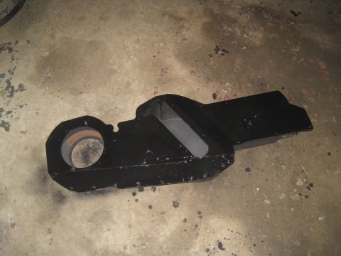 1979 Ford Bronco - Unidentified black metal automotive part on a concrete surface.