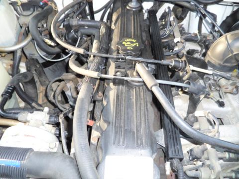 1994 Jeep Cherokee - The engine bay of a Jeep is shown, with various hoses and mechanical components filling the frame.