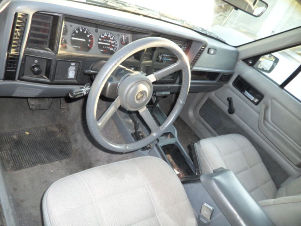 1994 Jeep Cherokee interior showing dashboard, steering wheel, and front seats