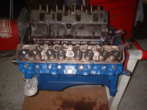 1969 Ford Mustang - Engine block assembly on a stand, showing valve springs and pushrods.