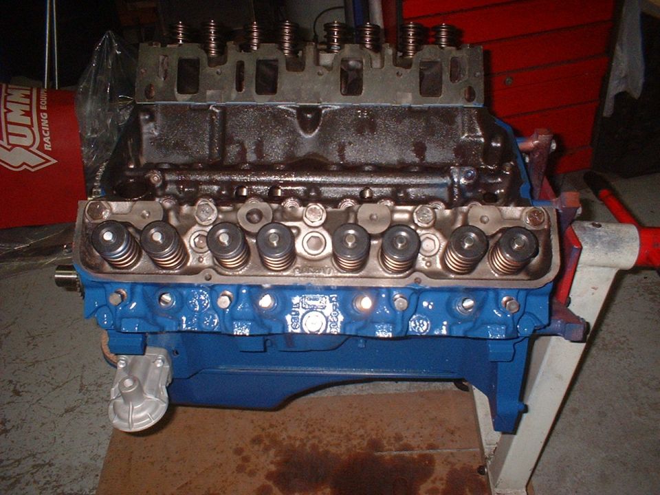 V8 engine block painted blue with valve train visible