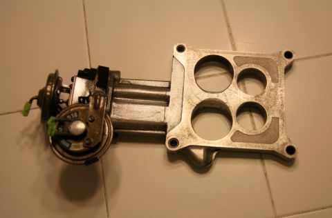 1976 Ford Ranchero - Holley carburetor base plate with four intake ports and vacuum diaphragm visible.