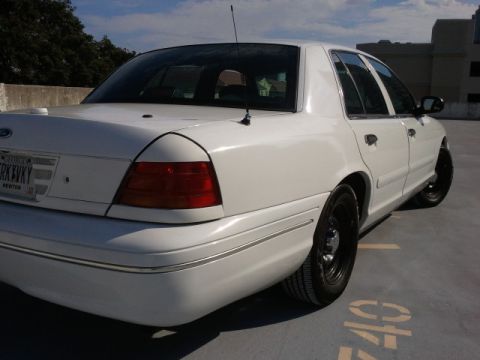 1998 Ford Crown Victoria - Rear view of a white 1998 Ford Crown Victoria parked on a rooftop.