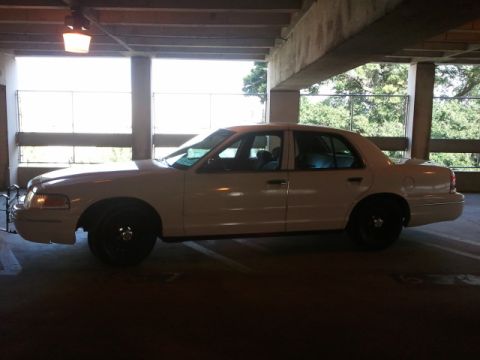 1998 Ford Crown Victoria - Side profile of a 1998 Ford Crown Victoria sedan parked indoors.