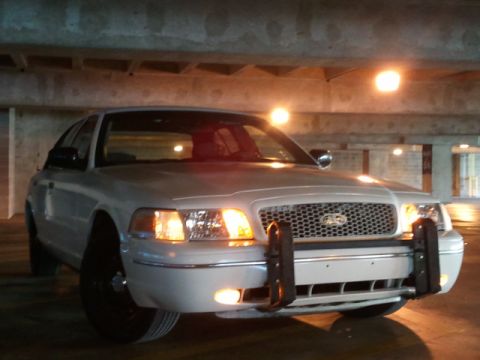 1998 Ford Crown Victoria - Front view of a 1998 Ford Crown Victoria police car parked in a garage.