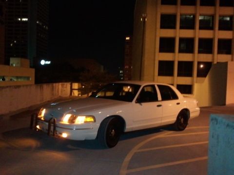 1998 Ford Crown Victoria - White 1998 Ford Crown Victoria parked in a lot at night.